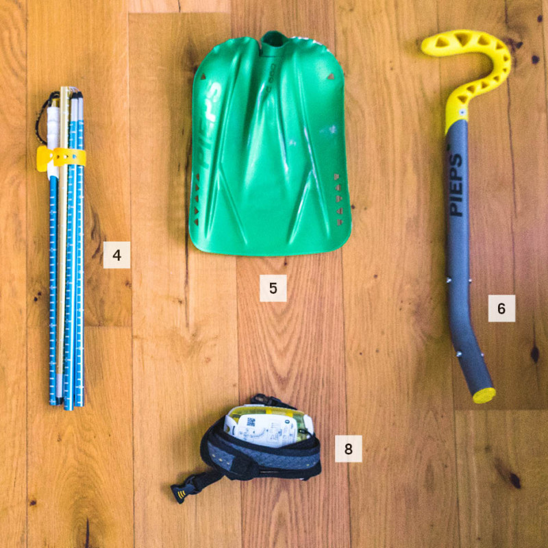 Top, from left to right: helmet, headlamp, probe, shovel (blade and shaft) Bottom from left to right: Goggles, smartphone, transceiver.
