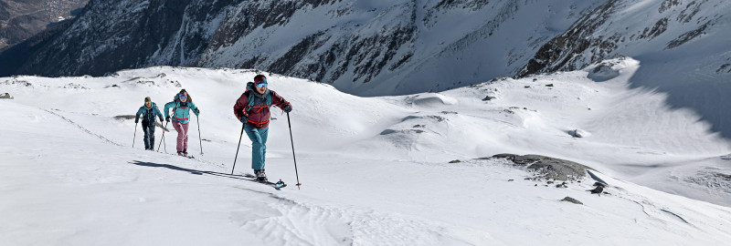 A group of ski touring enthusiasts in the snow-covered mountains.