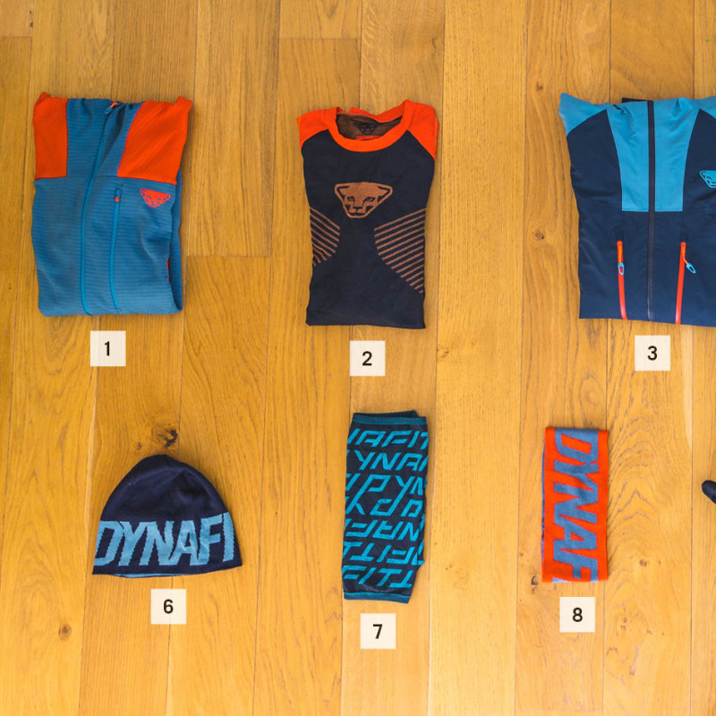 Top from left to right: Mid layer, base layer, hardshell jacket, down jacket, touring pant Bottom from left to right: Hat, neck gaiter, headband, gloves, socks, sunglasses